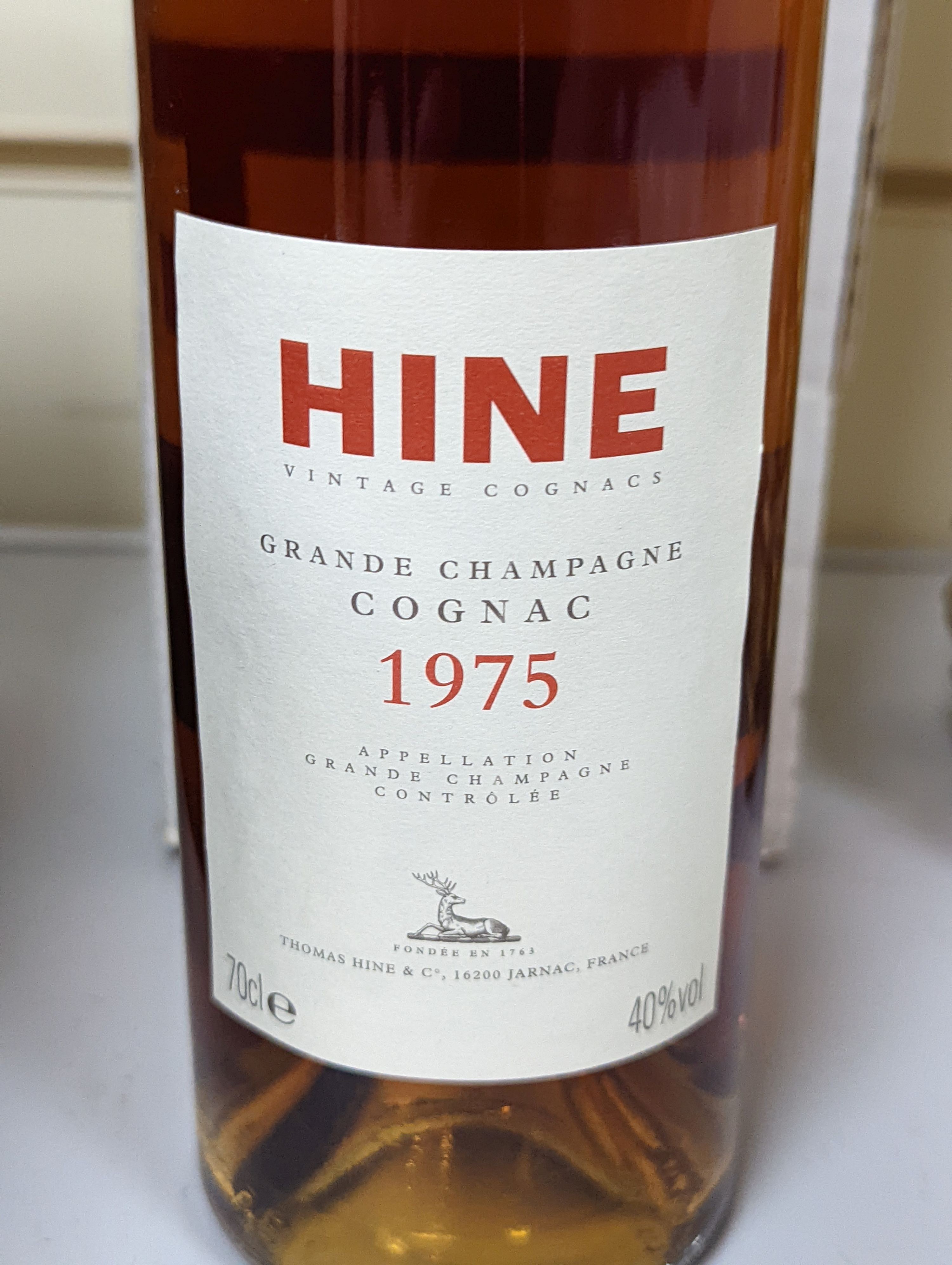 One bottle of Hine Grand Champagne Cognac, 1975. Original cardboard box.